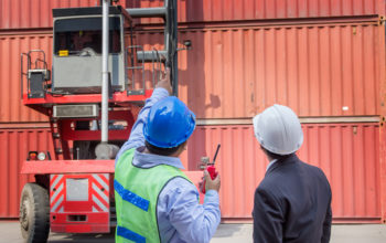 foreman control forklift handling follow order from his manager for move the container box loading